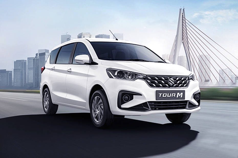 White MPV cab driving in city